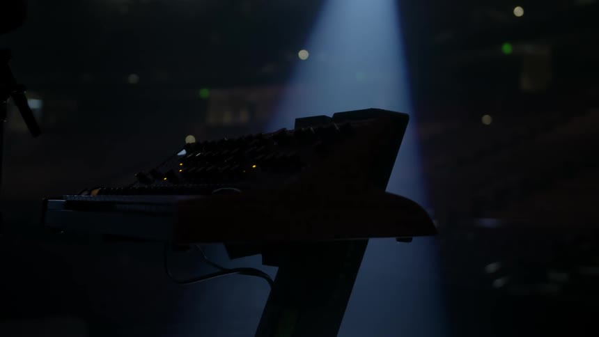 A keyboard sits on a stage