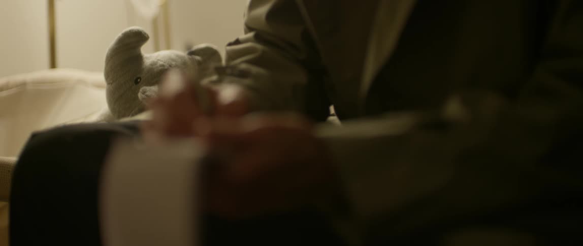 A woman writes in a small notepad with a pen
