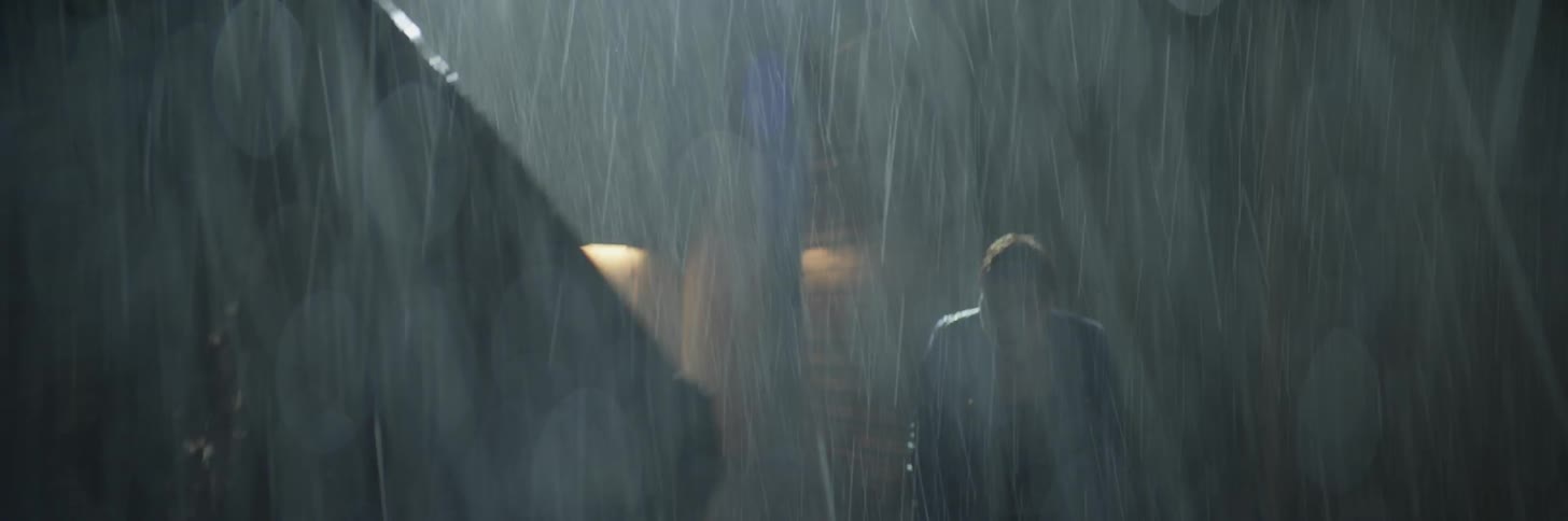 A man and woman fight in the rain