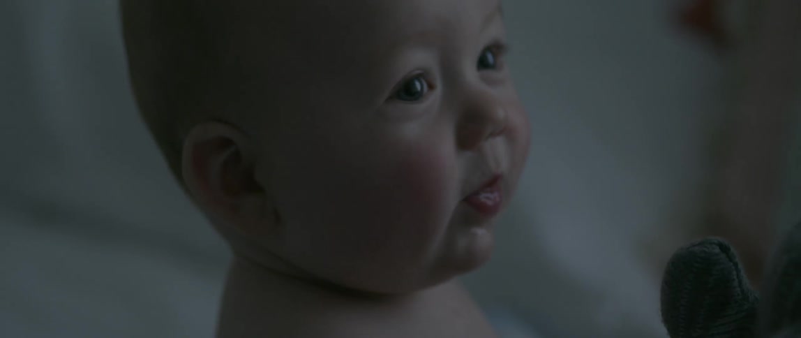A baby laughs and smiles