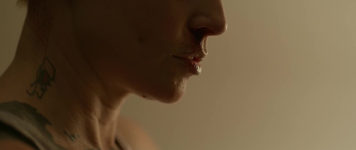 A woman is drawing in a breath and swallowing