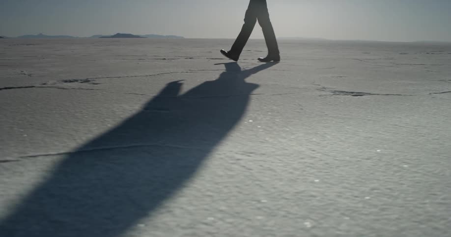 A person walks across a glittering white expanse