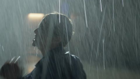 A man and woman fight in the rain