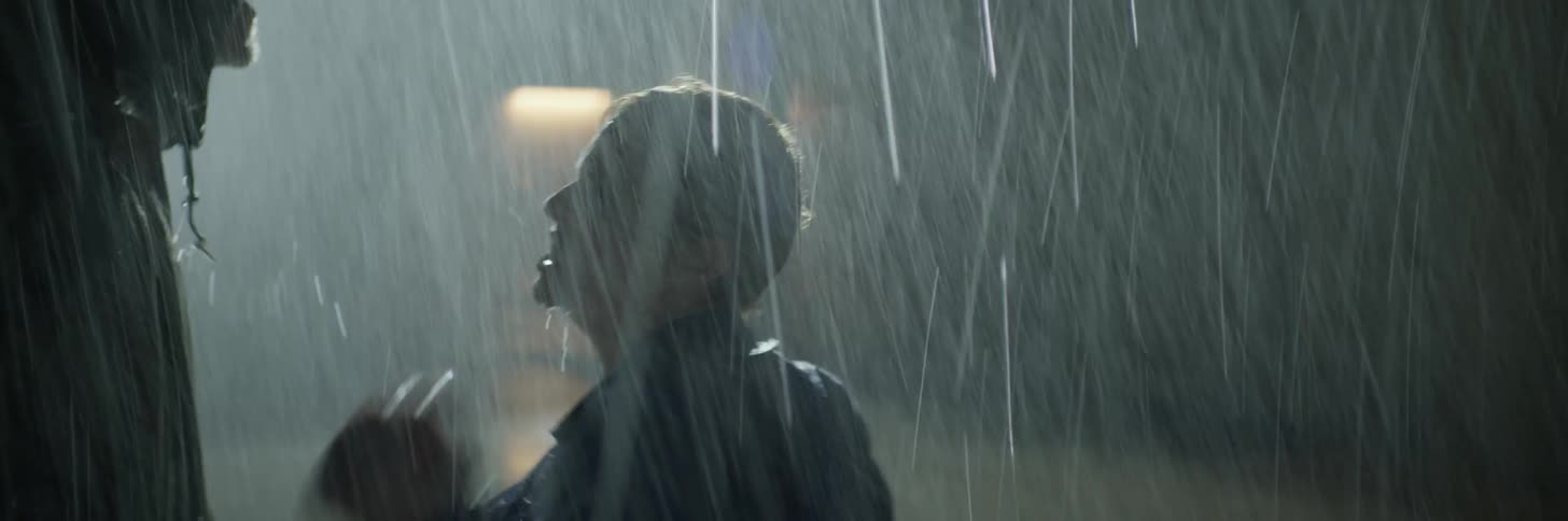 A man and woman fight in the rain