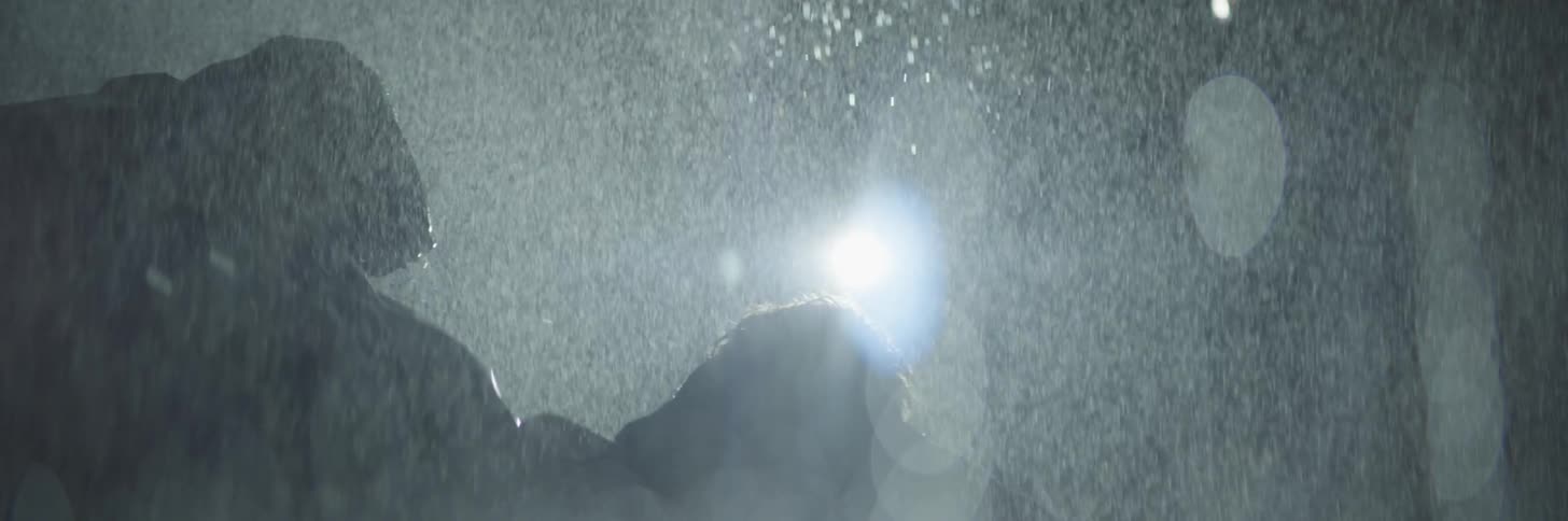 A man and woman fight in the rain