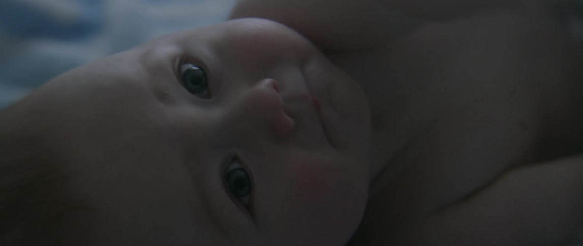 Baby laying down and waving its arms
