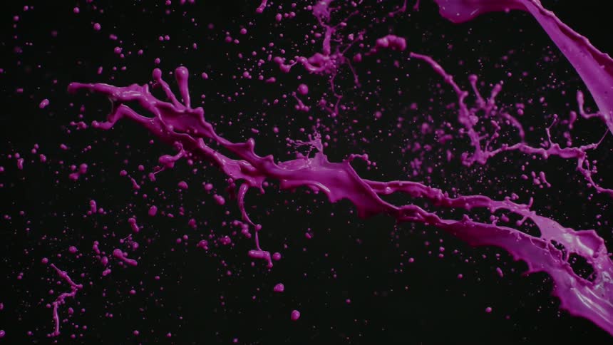 Pink liquid paint splashes through the air