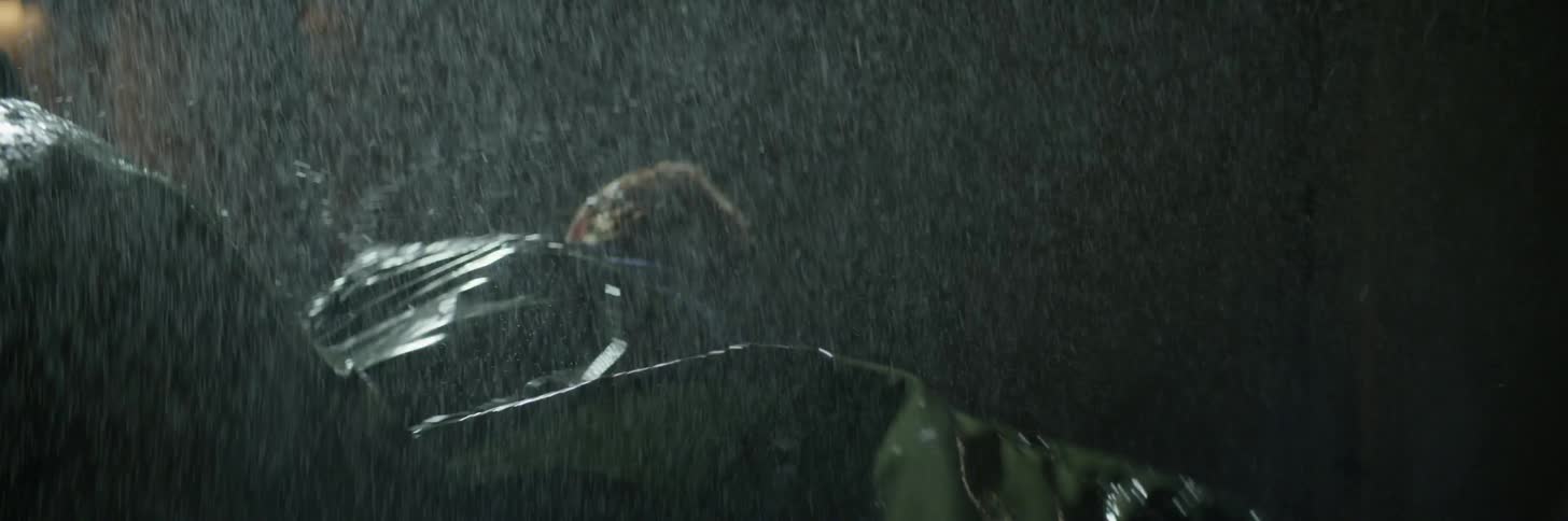 A man and woman fight outside in the rain