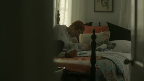 Man laying on a bed with a baby