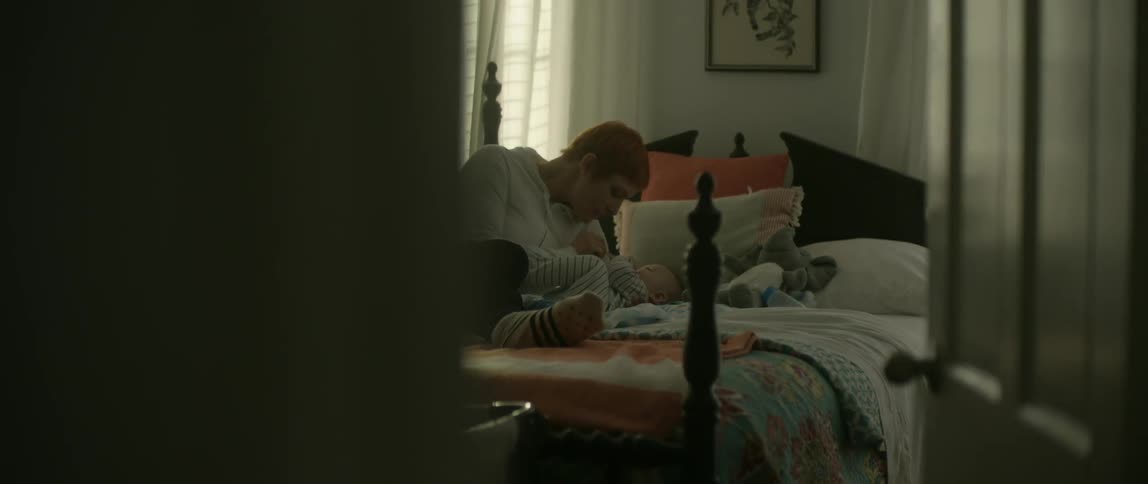 Man laying on a bed with a baby