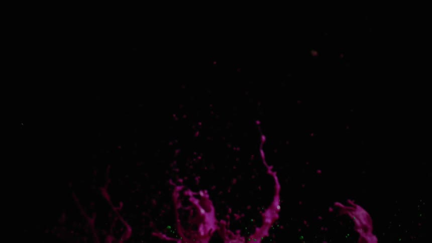 Pink and green paint liquid splashes upward