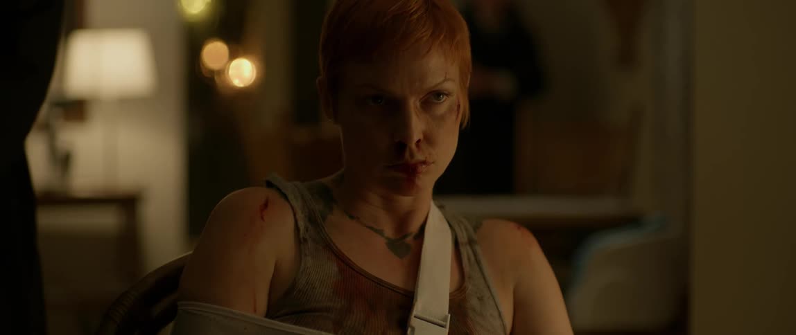 A woman with her arm in a sling is covered in blood