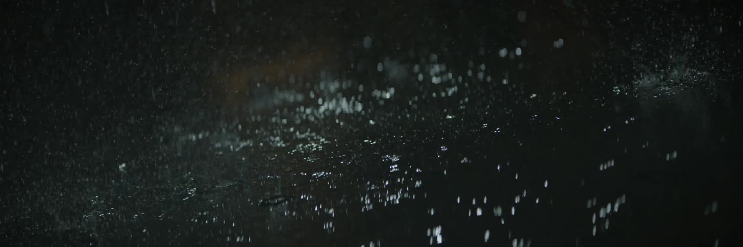 Rain falls on asphalt