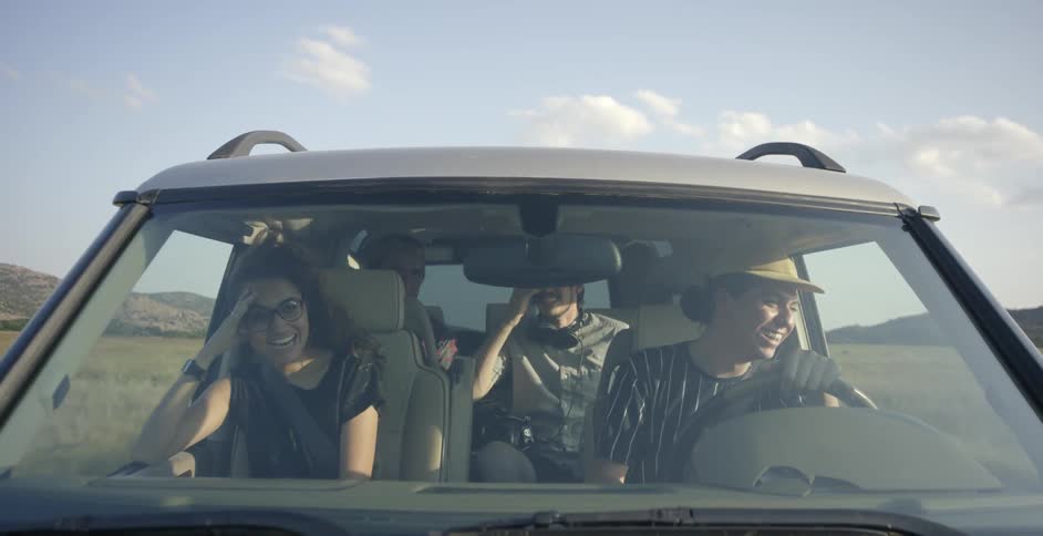 People ride in a vehicle in a rural area