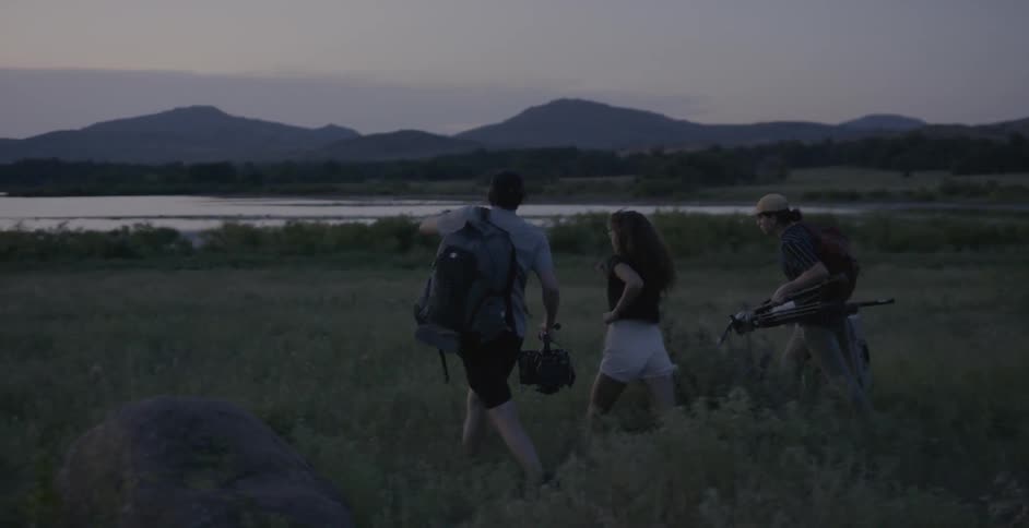People are running down the field with film equipment