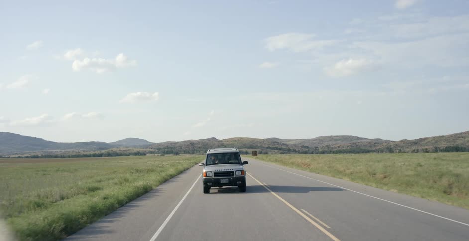 An suv pulls away from the breakdown lane and heads out onto the highway