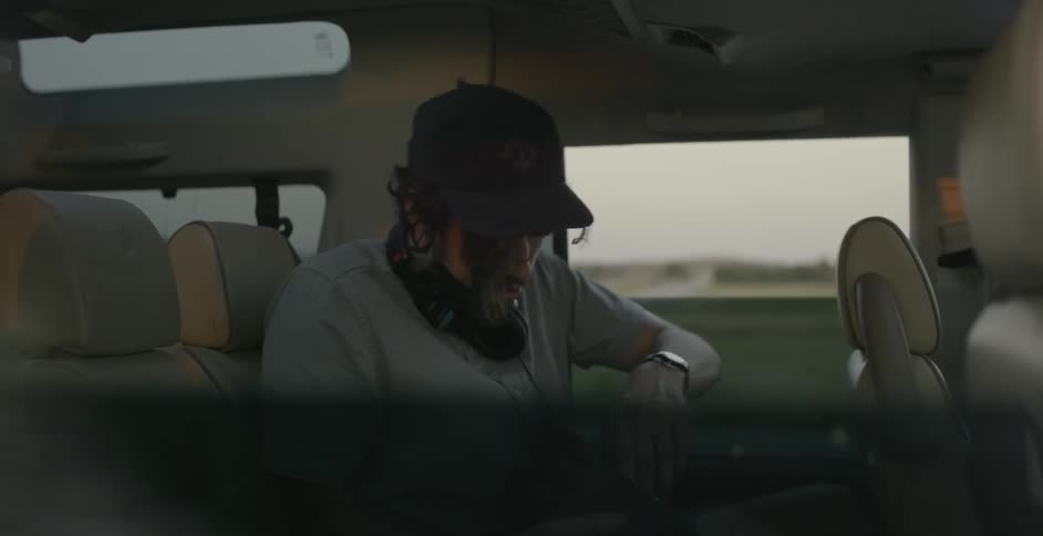 Man sitting in a vehicle looking down