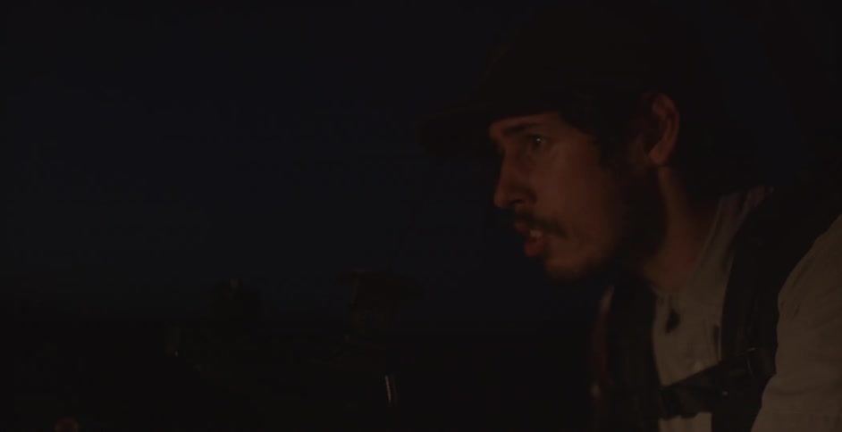 A man filming outside in the night time