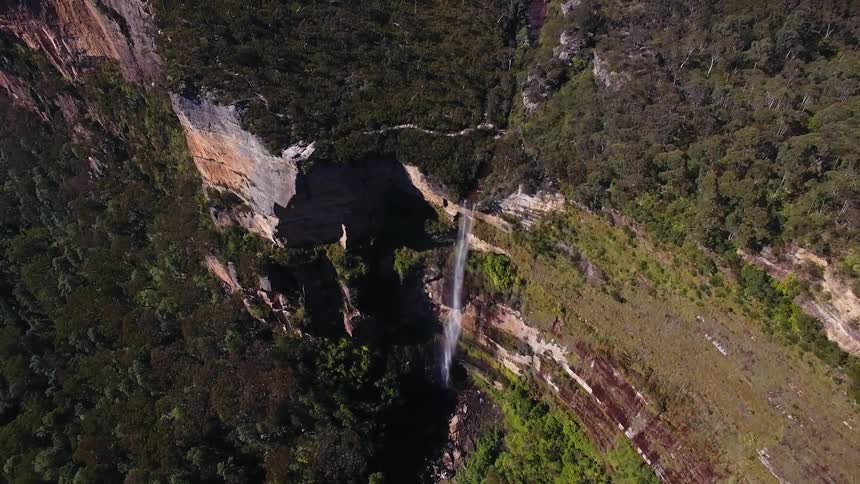 The edge of this cliff has water going off it