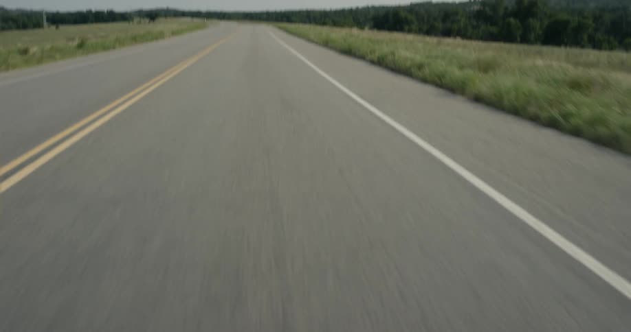 A road runs through a rural area on a sunny day