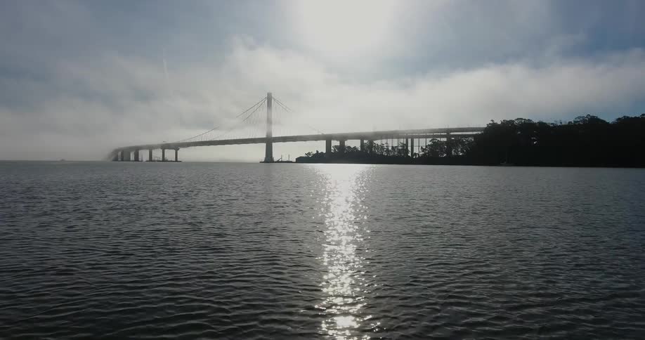 Clouds roll over a bridge during the day