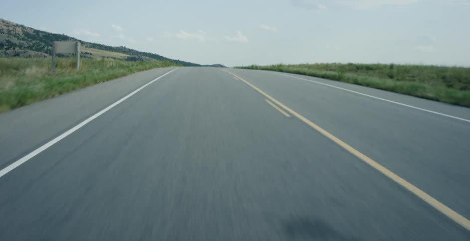 Traveling view of a highway in the country on a cloudy day