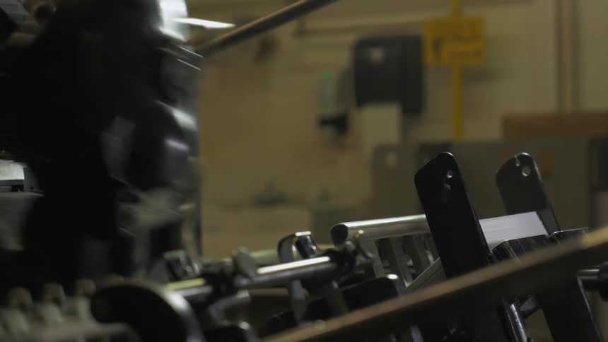 A printing machine is stacking sheets of paper