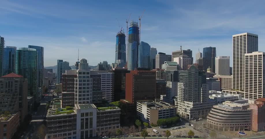 The large city has some tall towers in the middle