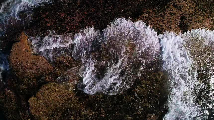 Water splashing up on a rocky shore