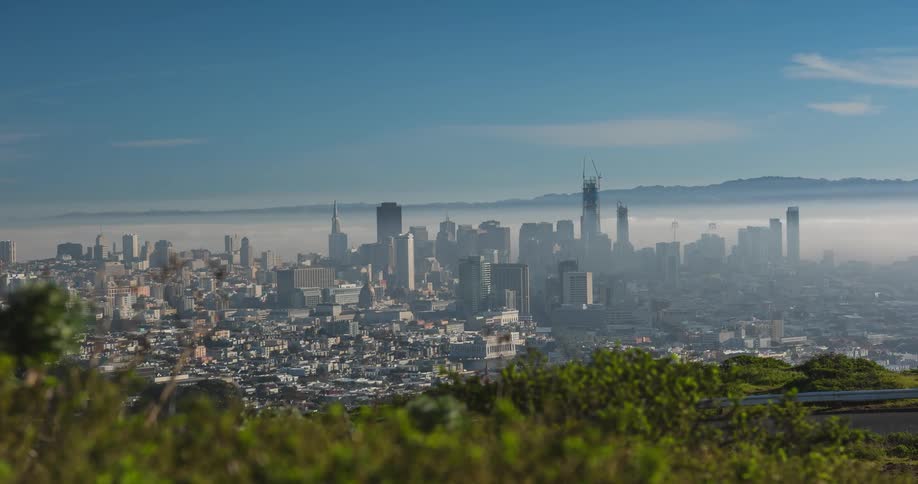 Clouds rolling over skyscrapers in a large city