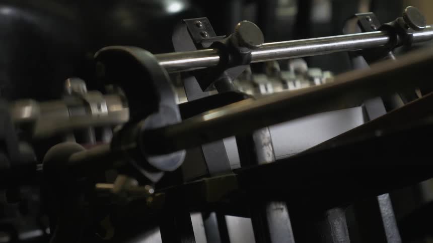 A machine is moving punching it's metal pieces together
