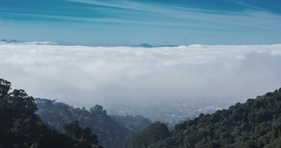 Clouds float over a valley on a sunny day