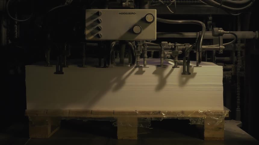 A machine is stacking paper fast