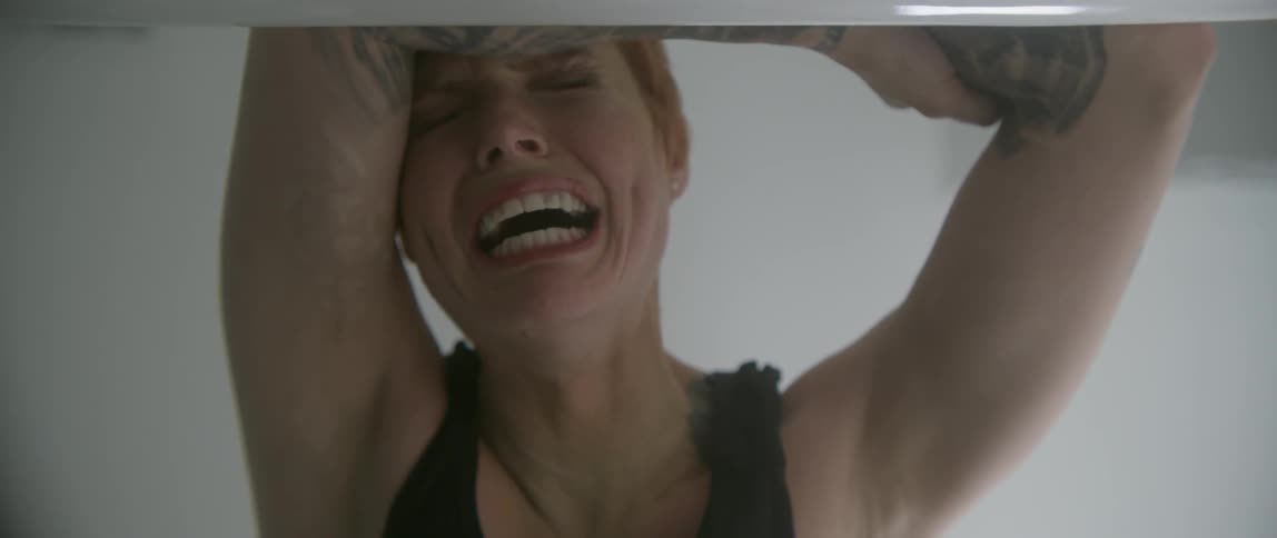 A red haired woman cries intensely