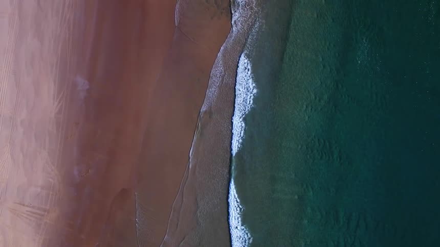 The clear waters hit the clean sand below