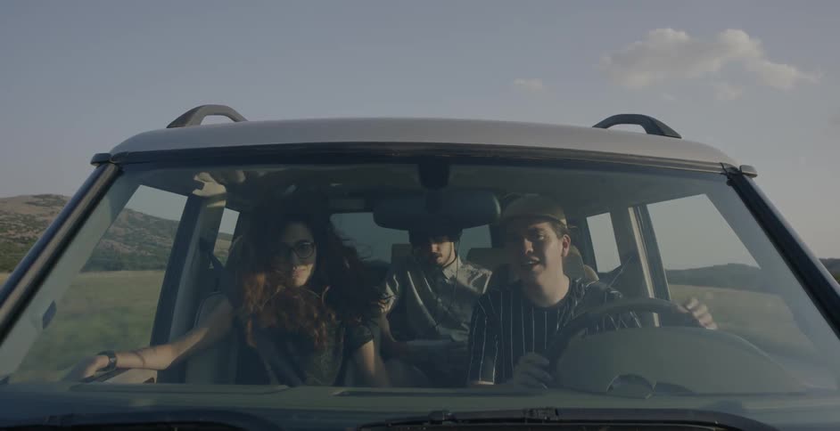 People ride in a car in a rural area
