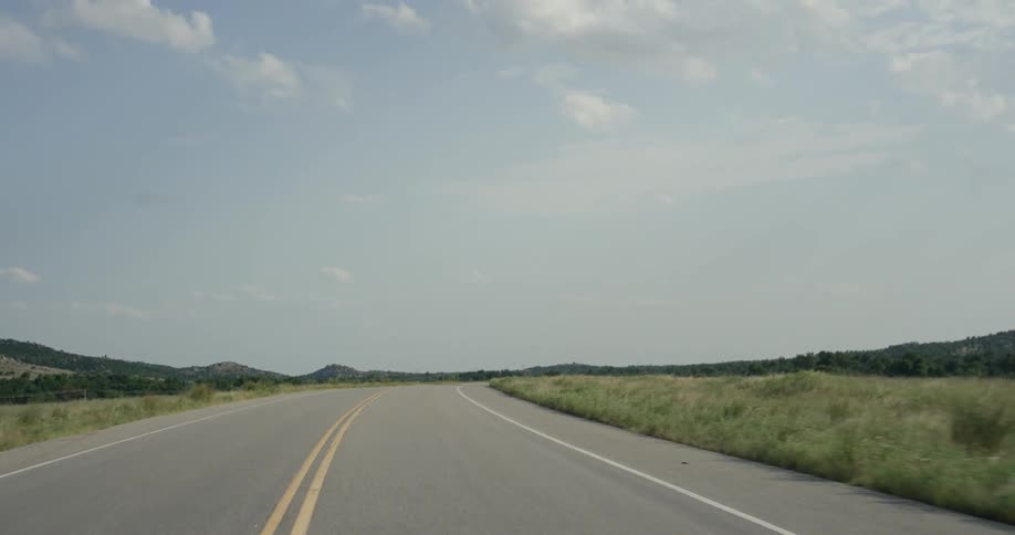 Traveling view of a highway in the country on a cloudy day