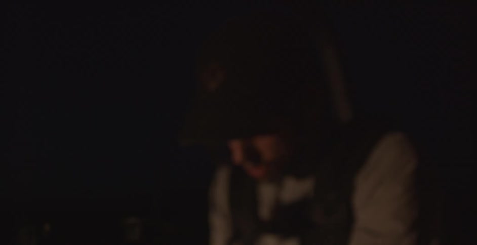 A man is working in a dark room