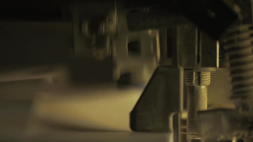 Papers flip quickly under a machine