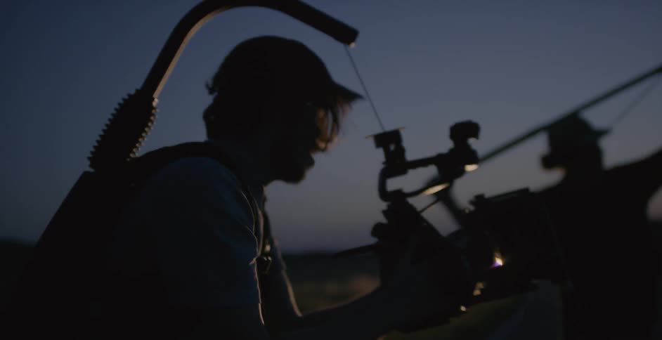 A crew is filming and taking sound outside at dawn