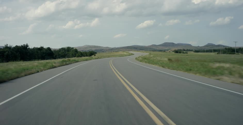 Traveling view of a highway in the country on a cloudy day