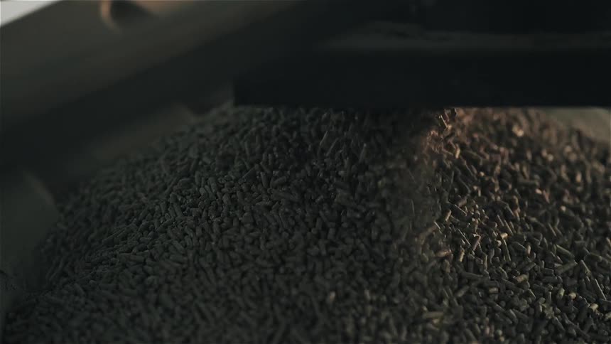 Some grains being put into a container by a piece of equipment