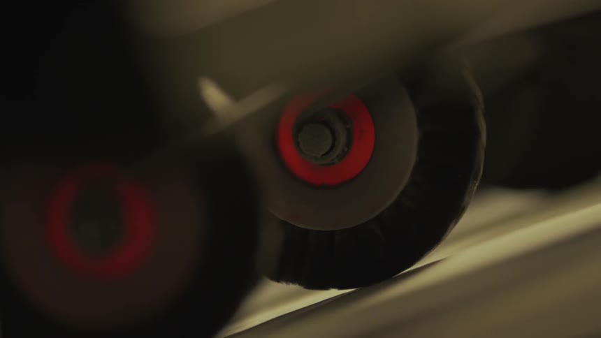 Roller wheels on machinery turn and propel material along