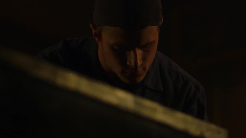 Man looking down in a dimly lit room