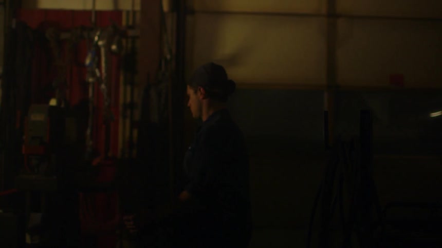 Man walking in a garage at night