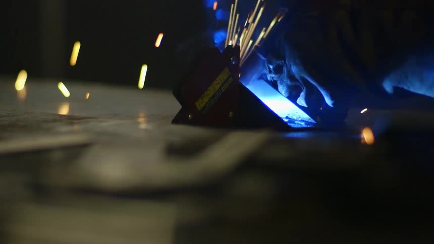 Person welding in a dark area