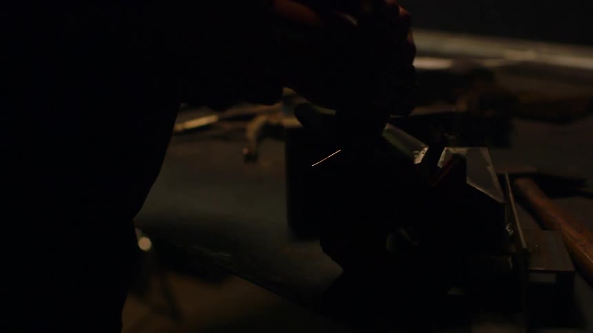 A man using a grinder to grind something