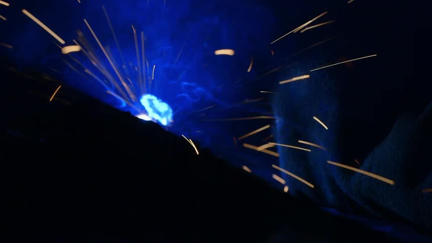 A person making sparks with something in the dark