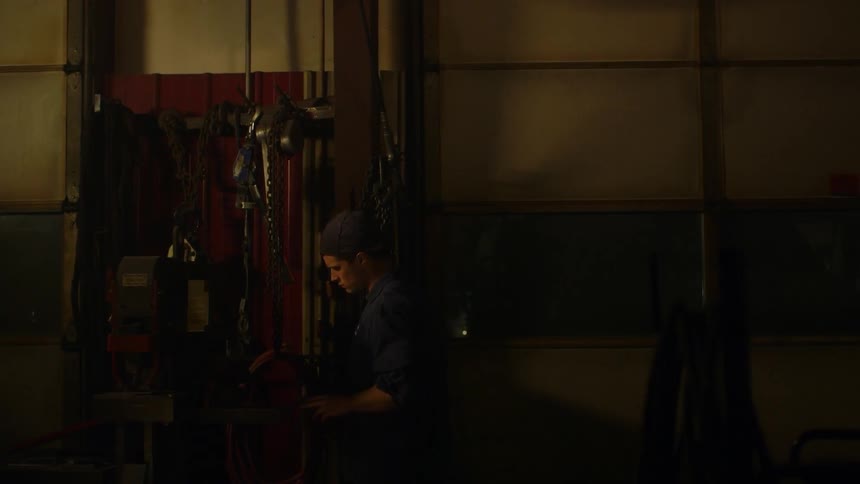 Man walking in a garage at night