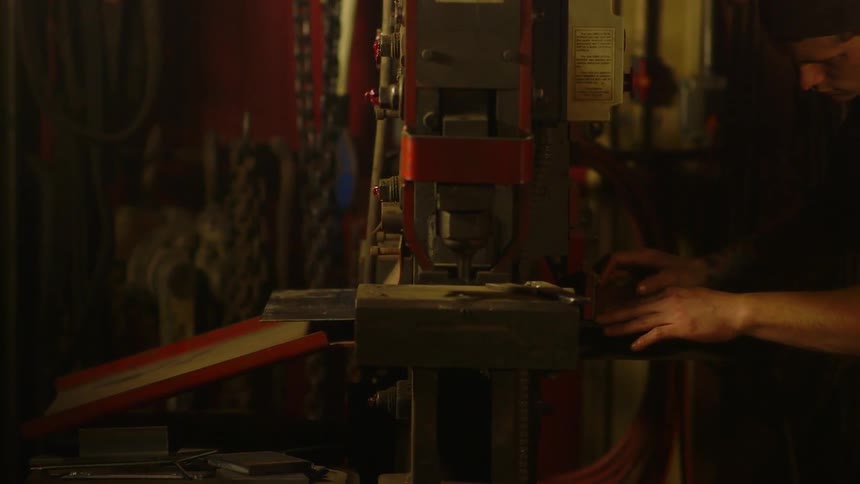 Hand pushing a small sheet into a machine